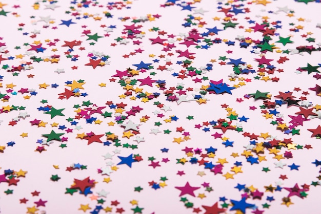 Colorful confetti stars on the background