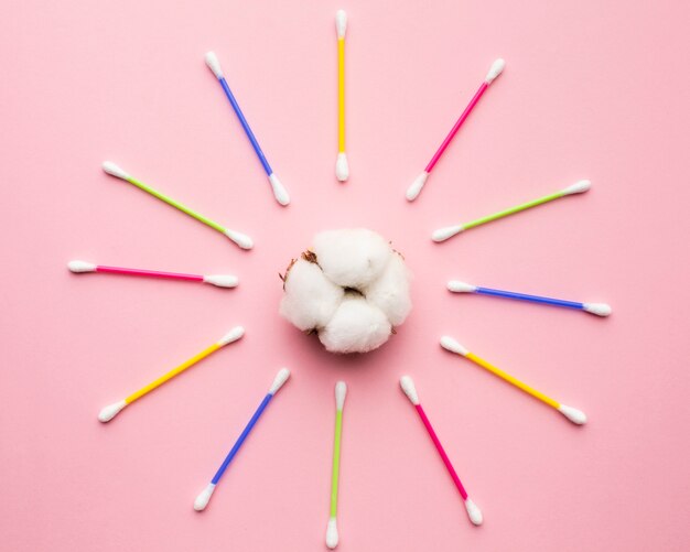 Colorful cotton buds surrounding cotton balls