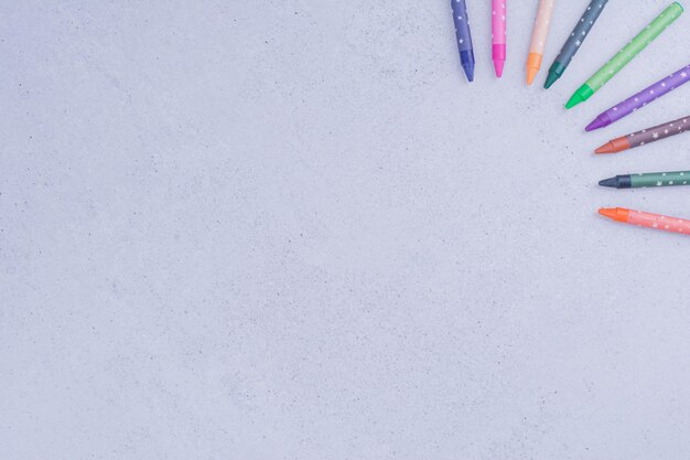 Colorful crayons isolated on grey surface