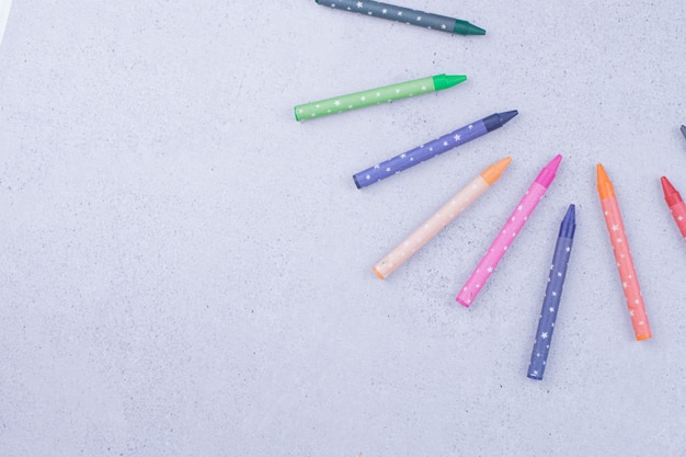 Free photo colorful crayons isolated on grey surface