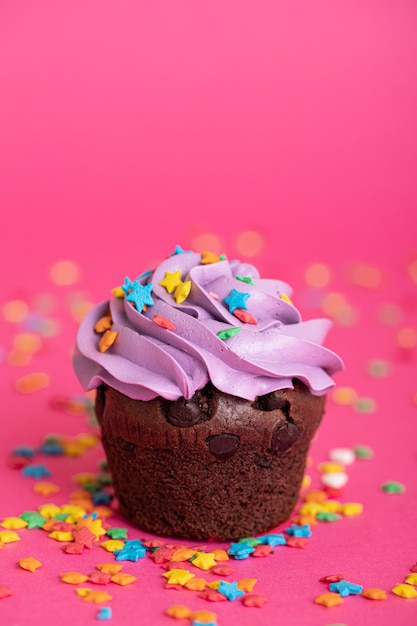 Colorful delicious cupcake with frosting on top