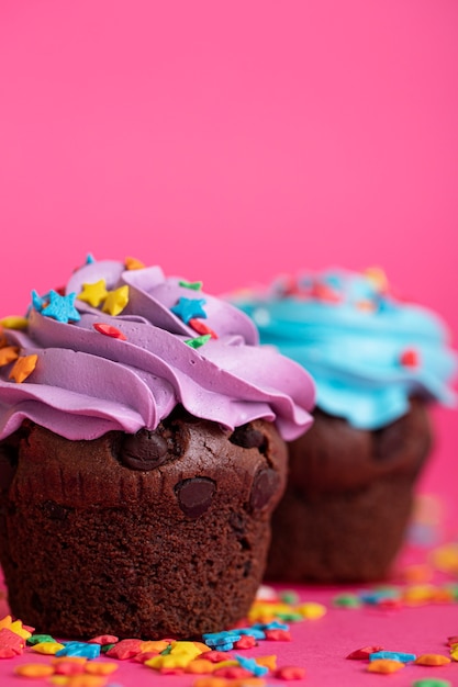 Colorful delicious cupcakes covered in frosting