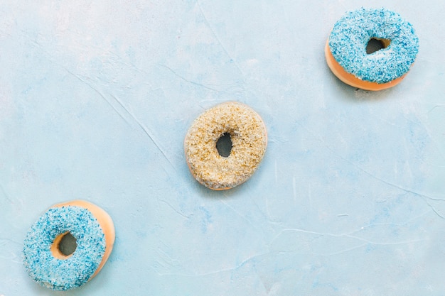 Free photo colorful delicious donuts on blue background