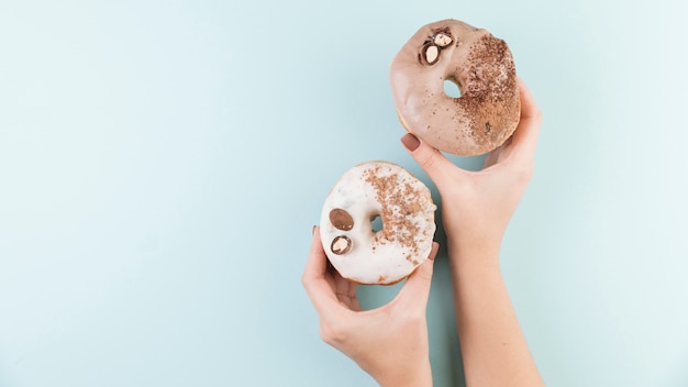 Colorful donuts with hands