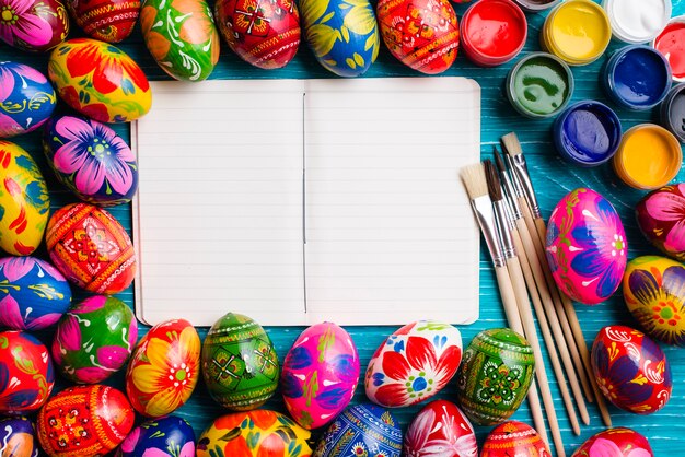 Colorful easter composition with blank notebook