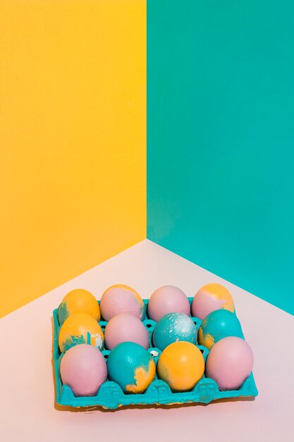 Colorful Easter eggs in big rack on bright table