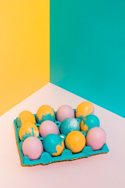 Colorful Easter eggs in big rack on table