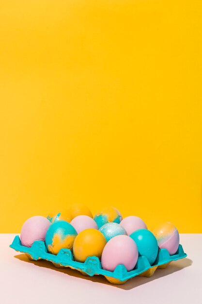 Colorful Easter eggs in bright rack on table