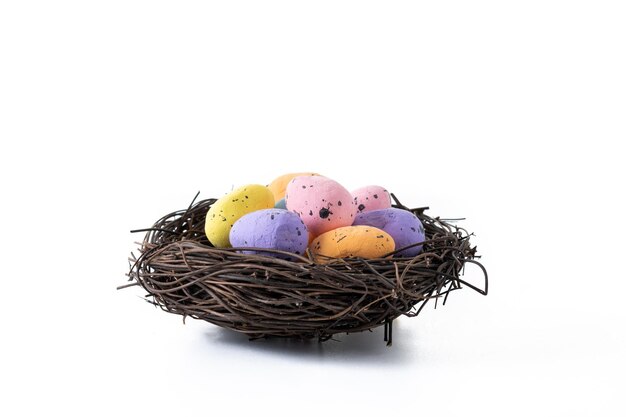 Colorful Easter eggs inside a nest isolated on white background