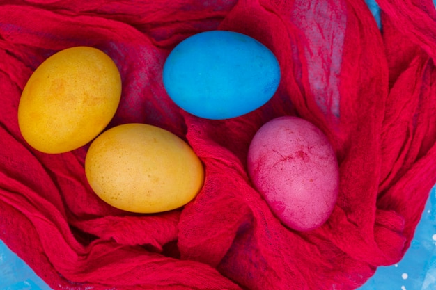 Colorful Easter eggs on red cloth