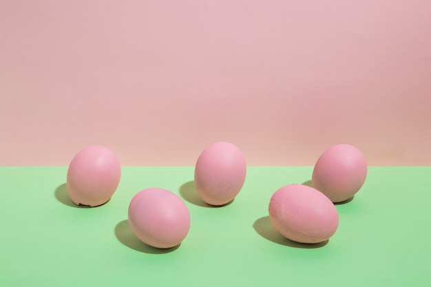 Colorful Easter eggs scattered on green table