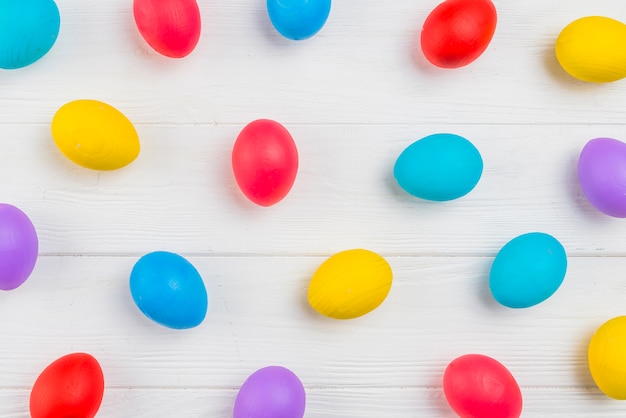 Colorful Easter eggs scattered on table