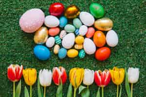 Free photo colorful easter eggs and tulips