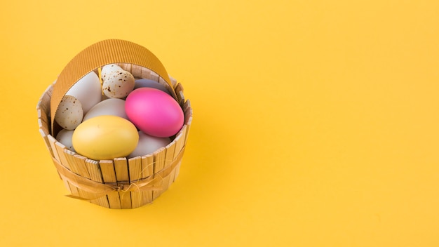 Colorful Easter eggs in wooden basket