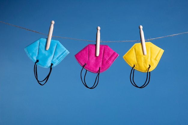 Free photo colorful ffp2 masks hanging on wire still life