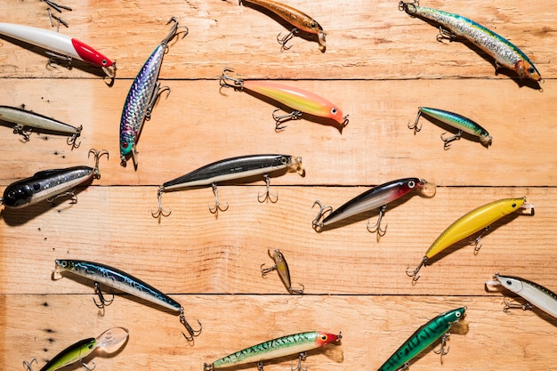 Free photo colorful fishing lures on wooden desk