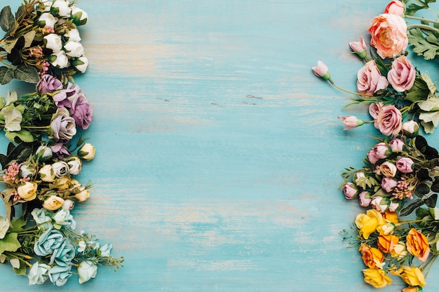 Free photo colorful flowers on blue light wooden background.