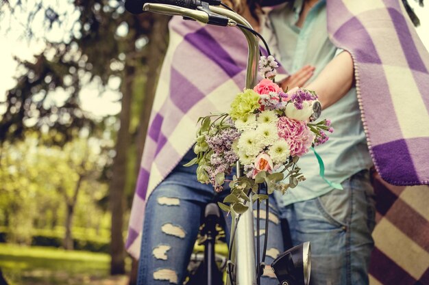 Colorful flowers bouquet on bicycle handlebar. summer time