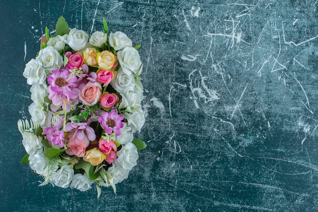 Colorful flowers in a box , on the blue background.