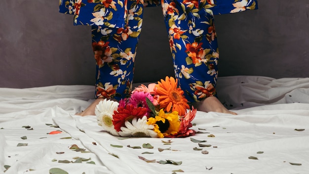 Free Photo colorful gerbera flowers in front of man's foot