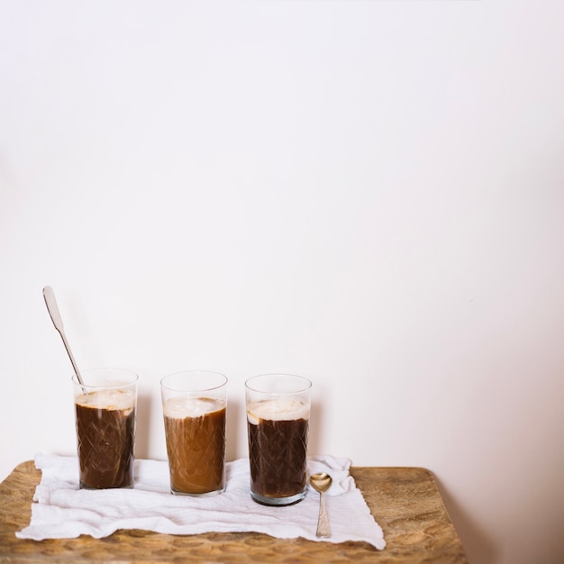 Colorful glasses with coffee and ice