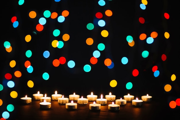 Colorful lights near candles