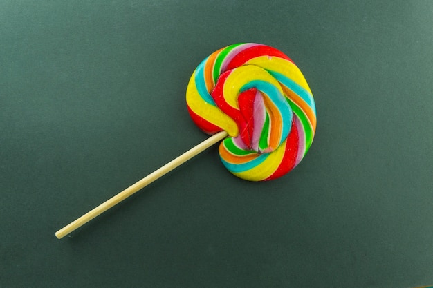 Free photo colorful lollipop on green