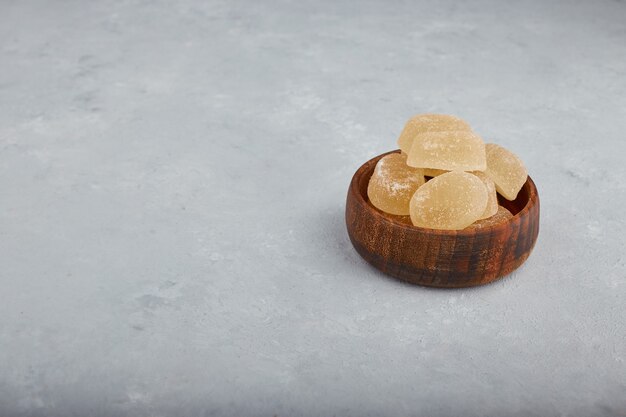 Colorful marmelade delights in a wooden bowl. 