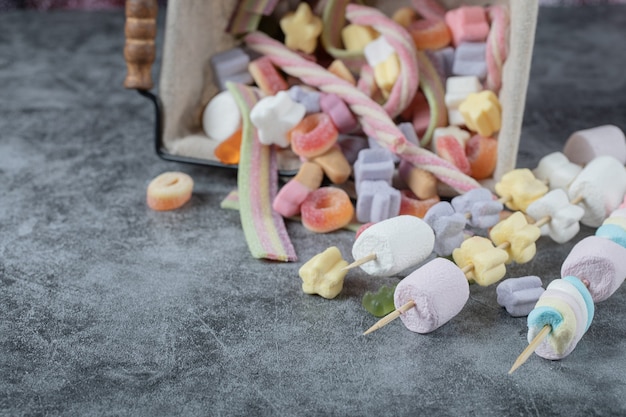 Free Photo colorful marshmallows on the wooden sticks for grilling.