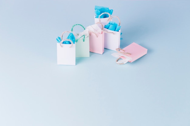 Free photo colorful paper shopping bags isolated on blue background