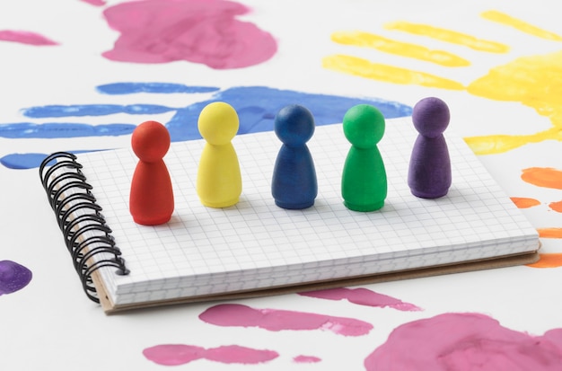 Free photo colorful pawns on white notepad