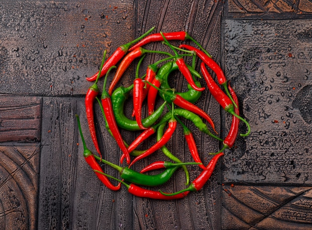 Colorful peppers on a dark stone tile background. top view.