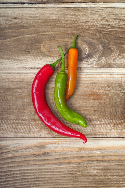 Free Photo colorful peppers on wooden board