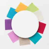 Free photo colorful pieces of cloths arrangement with a white circle centered