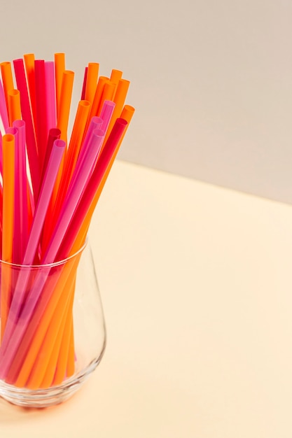 Colorful plastic straw collection in glass