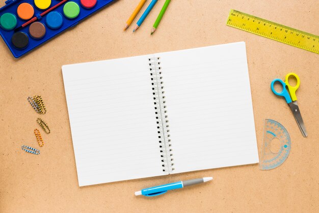 Colorful school supplies on plain background