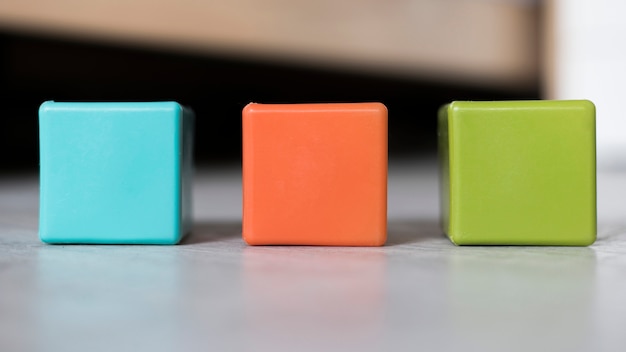 Free photo colorful set of cubes lined up on floor