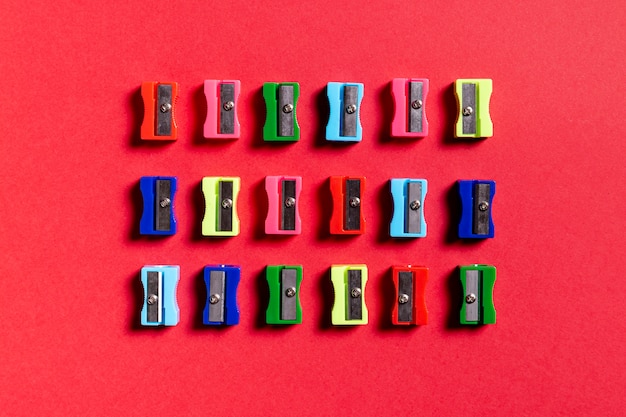 Free Photo colorful sharpeners on red background