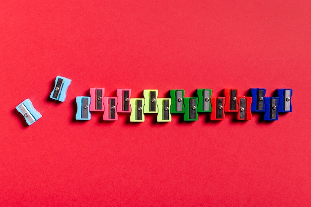 Free Photo colorful sharpeners on red table