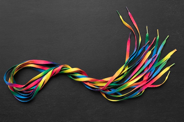 Colorful shoelaces arrangement on dark background