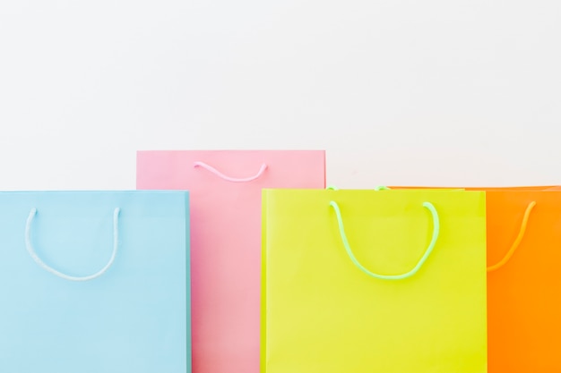 Free photo colorful shopping bags on white surface