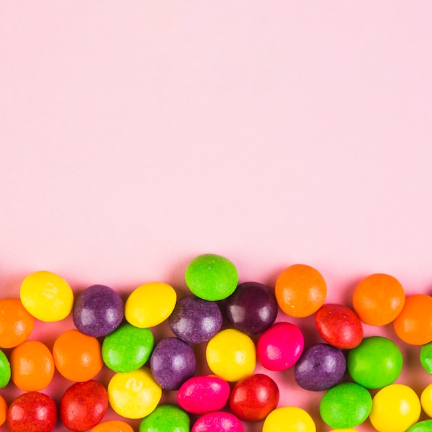 Free photo colorful sweet candies on pink background