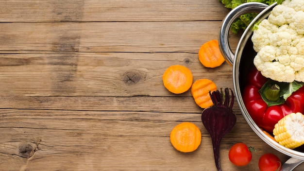 Colorful vegetables arrangement on wooden background with copy space