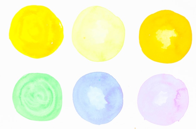 Colorful watercolor blots on white backdrop