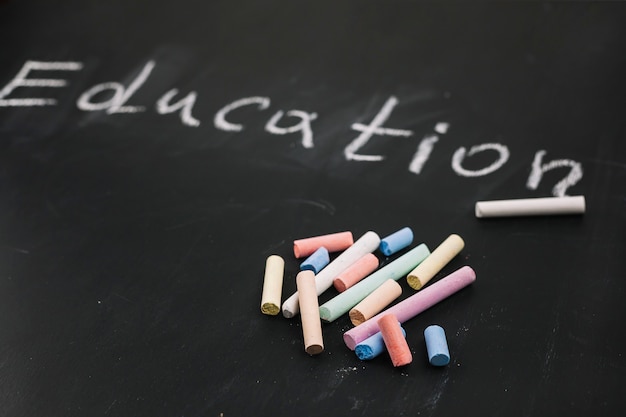 Free Photo colourful chalks on black board 