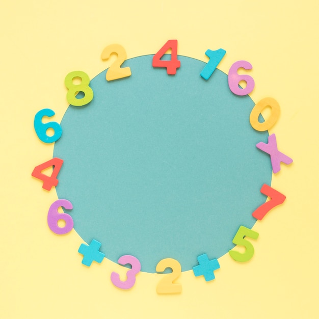 Free photo colourful math numbers frame surrounding blue circular shape