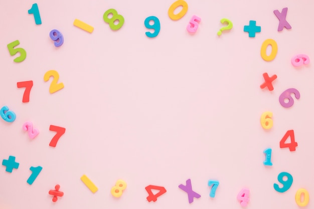 Colourful math numbers and letters frame with copy space top view