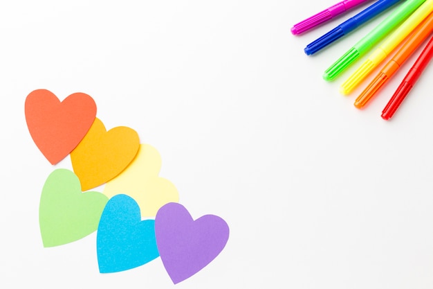 Colourful pencils and paper hearts