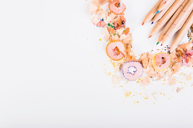 Colourful pencils surrounding shavings