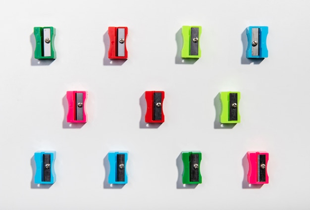 Free photo colourful sharpeners arrangement on minimalist background